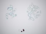 many small pieces of glass on a white surface
