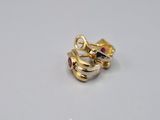 a close up of a pair of gold rings with ruby stones
