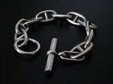 silver chain bracelet with a clasp on a black background
