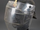 an image of a helmet with a clear face shield on a black stand
