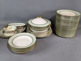 a lot of plates and cups that are sitting on a table