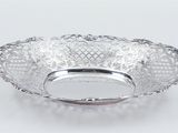 an antique silver plate with a decorative design on the rim