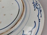 a blue and white plate with a blue design on it