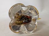a glass ring with a flower inside of it on a table