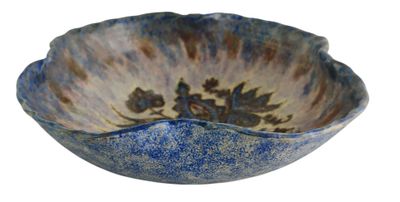 a blue and white bowl with a flower design on it