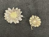 pair of silver and gold tone flower brooches