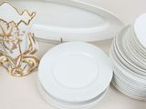 many plates and a vase sitting on a table