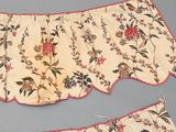two pieces of cloth with floral designs on them on a gray surface