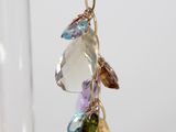 a close up of a pair of earrings on a glass stand