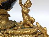 a black and gold vase with a clock on top of it