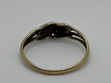 a close up of a gold ring on a white surface