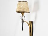 brass and glass sconce with a lamp shade on the wall
