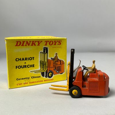 a toy forklift truck with a box on the back