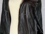 brown leather jacket on a mannequin dummy with a white torso