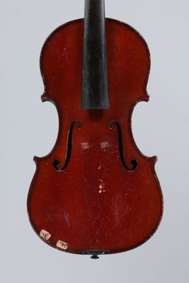 a red violin with a black bow hanging from it ' s back