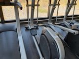 a row of stationary exercise bikes in a gym