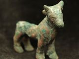 a small figurine of a horse on a black background