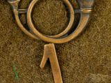 a close up of a brass object on a piece of cloth