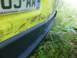 a close up of a yellow car with a license plate on it
