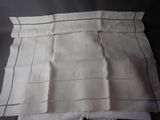 four pieces of white cloth with black stitching on them