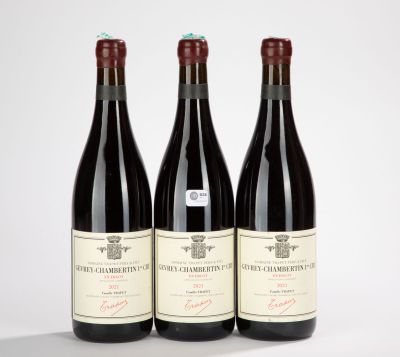 three bottles of wine sitting on top of a table next to each other