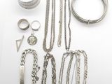 an assortment of silver jewelry including a ring, bracelet, ring, and other items