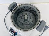 an overhead view of a kitchen scale with a strainer attached to it