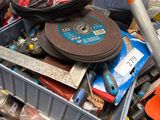 a pile of tools and other items in a bin