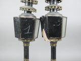 pair of black and gold lamps with birds on top of them