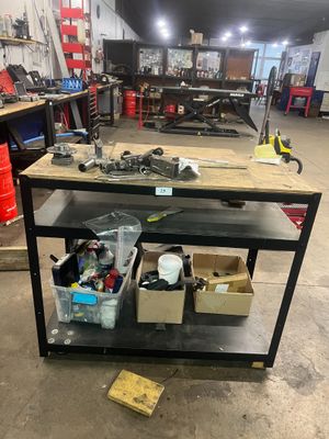 a workbench in a garage with many tools on it