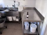 a kitchen with a sink and a counter with a bottle on it
