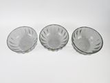 three clear glass bowls sitting on top of a white surface