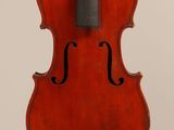 an old violin with a bow hanging from it ' s back