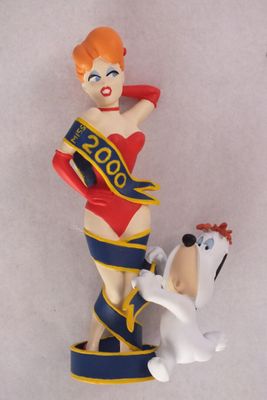 une figurine représentant une femme et un chien posée sur une table