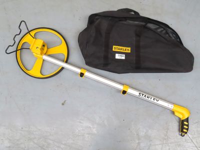 a close up of a metal detector and a bag on a floor