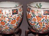two vases that have been decorated with flowers on them