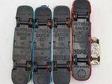 four skateboards are lined up in a row on a white surface