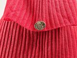 red pleated skirt with a gold button on the front