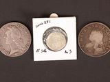 three different types of coins are shown on a black surface