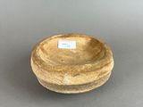 a small bowl with a label on it on a table