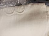 a white shirt with three rings on it sitting on a table