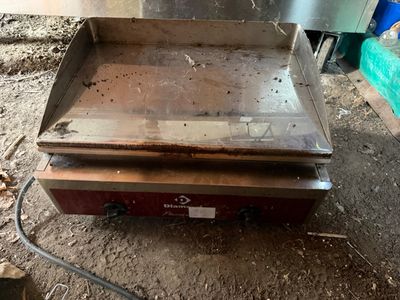an old stove that is sitting in the dirt