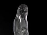 a glass sculpture of a woman with a fan on her head