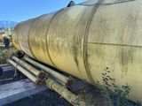 a large yellow tank sitting on the side of the road