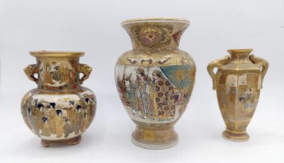 three vases are sitting next to each other on a white surface