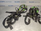 two pairs of black and green skis sitting on top of a table