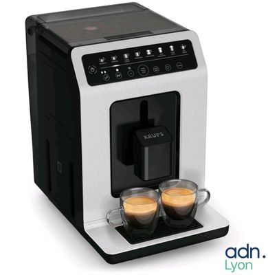 une image représentant une machine à café avec deux tasses de café posées devant