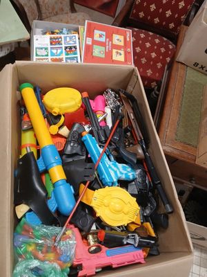 a cardboard box filled with toys and other items