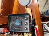 a small radio sitting on top of a wooden shelf