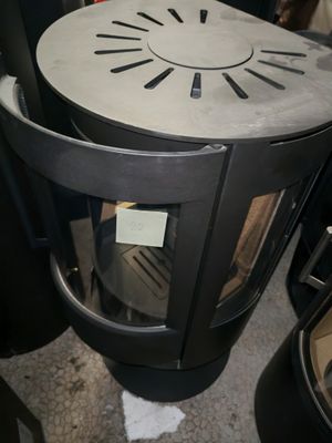 a black stove sitting in a room next to other stoves